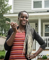 homeowner with keys in front of home