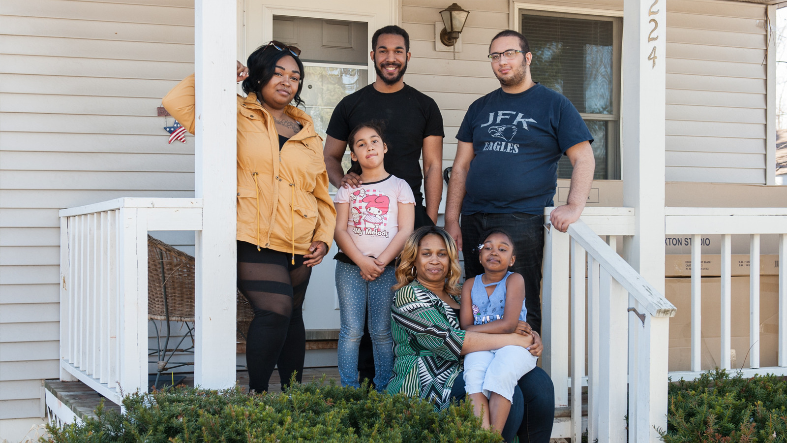 A homeowner and her family on their front porch.