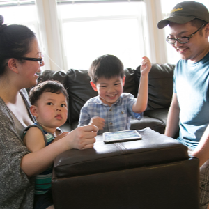 Kathy and David in their living room with their kids.